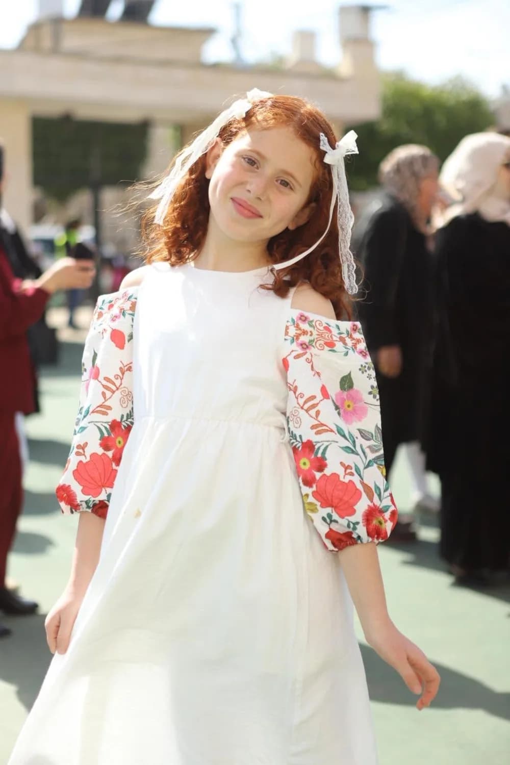 IMAS student in a floral celebration dress